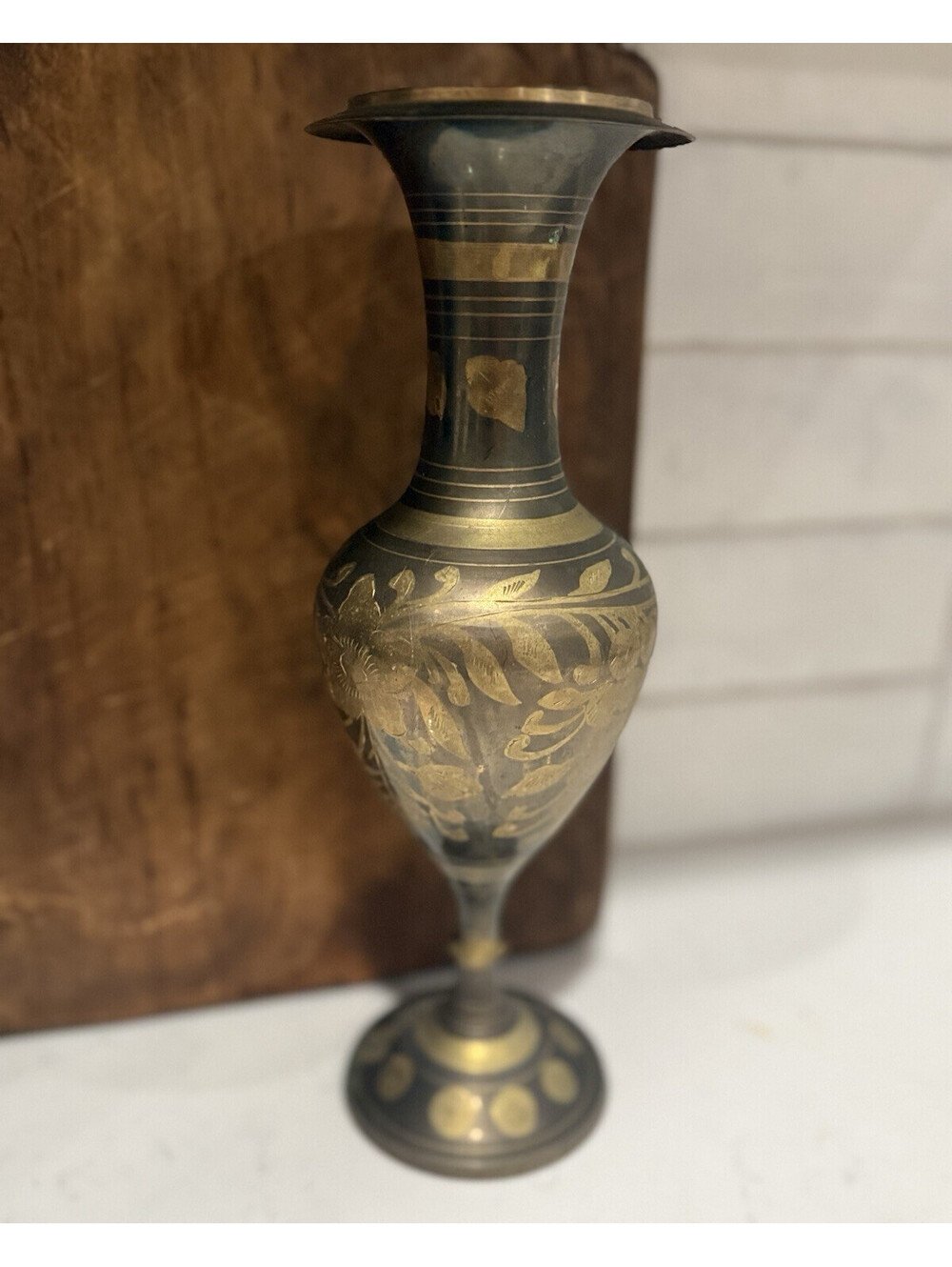 A vintage etched brass floral vase, handmade in India.
